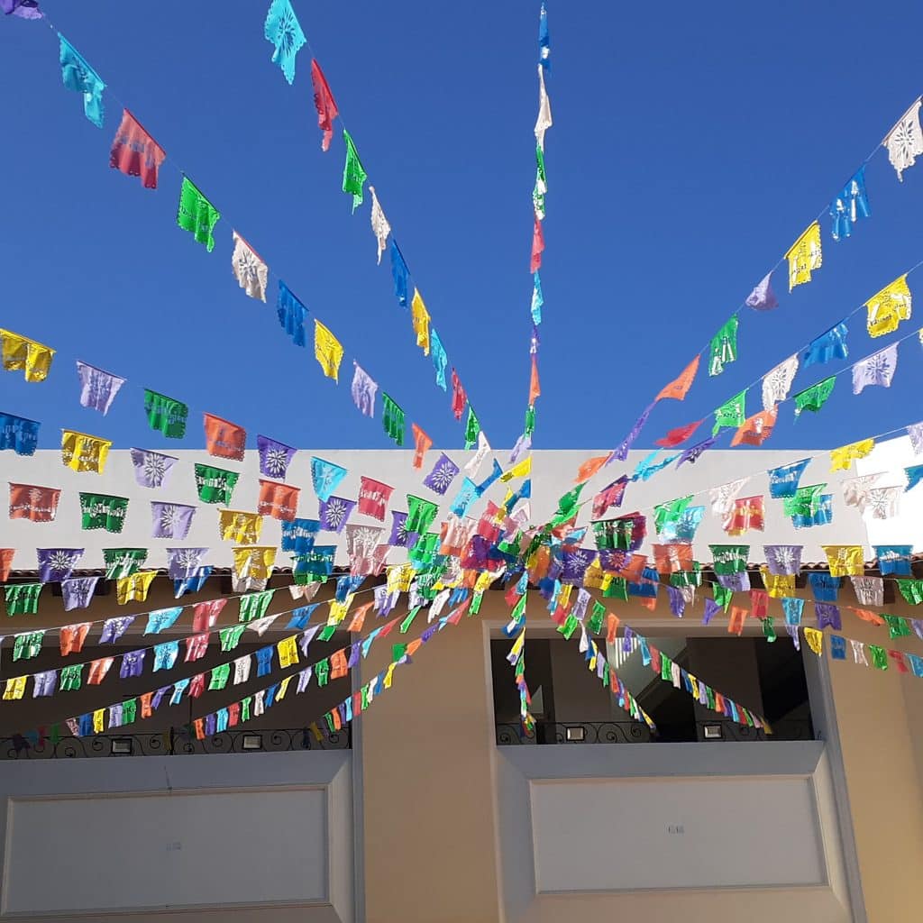looking up at colorful flags in Mexico